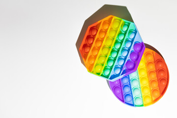 Pop It silicone sensory anti-stress Fidget kid toys colorful rainbow game isolated on white background, copy text space. Calming tools, adult stress reliever popping, trendy push bubble toys