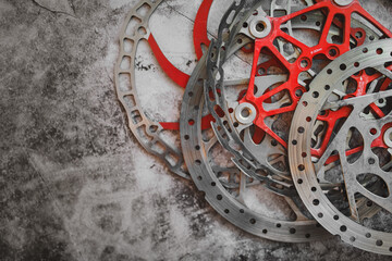 Worn mountain bike brake discs lying in the workshop. Flat lay bicycle workshop concept.