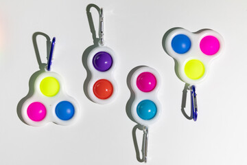 Simple Dimple - silicone sensory anti-stress Fidget toys colorful rainbow game isolated on white background, copy text space. Calming tools, adult stress reliever popping, trendy push bubble toys