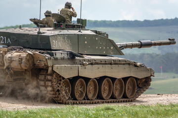close up of a british army Challenger 2 ii FV4034 main battle tank kicking up dirt in action on a...