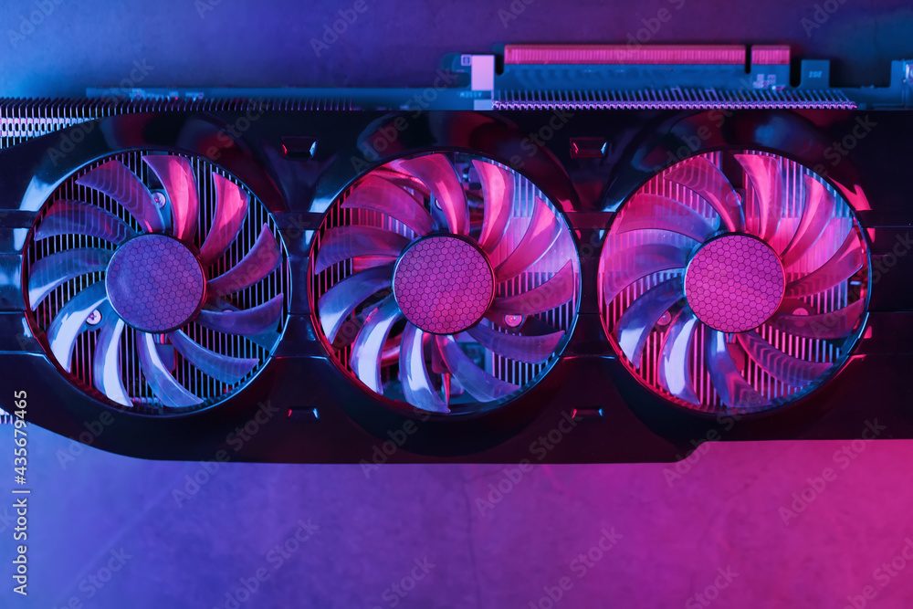 Poster a graphics card with a row of fans with a cyanotic purple backlight in a futuristic design.
