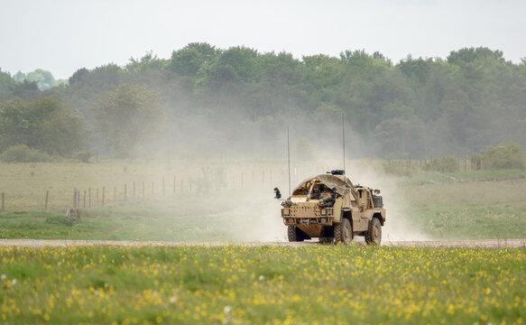 British army Supacat Jackal MWMIK rapid assault, fire support and reconnaissance vehicle on maneuvers in a demonstration of firepower, Salisbury Plain military training area UK