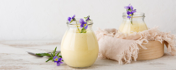 jars of mango panna cotta on a light table