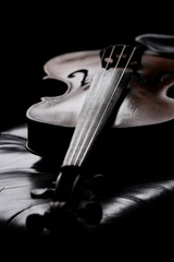 A viola or violin on a leather bench in a moody environment
