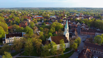 Fototapeta na wymiar Aerial View of Kuldiga Old Town With Red Roof Tilesand Evangelical Lutheran Church of Saint Catherine in Kuldiga, Latvia.