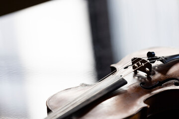 A violin or viola lying on a reflective surface