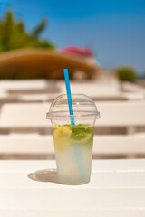 fresh summer drink on wooden table in open terrace cafe. shallow depth of field photo