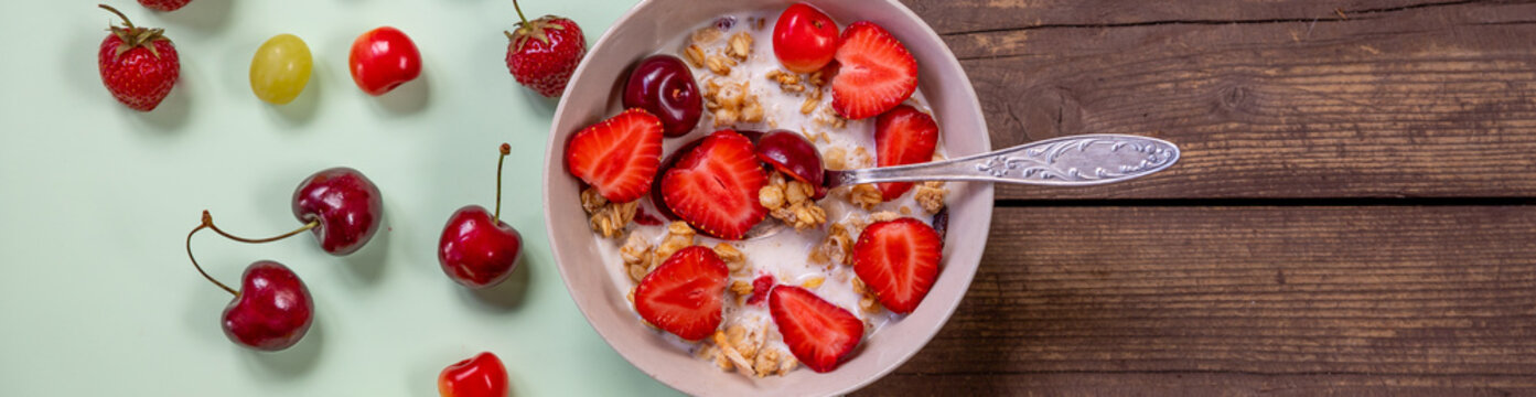 Multigrain wholewheat healthy cereals with fresh berry for breakfast overhead shot.Granola with yogurt and blueberry, cherries.Organic muesli with fresh fruits and yorgurt