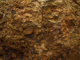 The photo shows a deserted rocky sandy road. Gray-orange tone. Minimalism. There are no people in the photo. Background. Texture. Place for your insert.