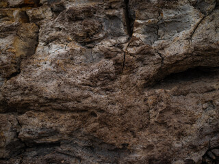 In the photo there is a rocky road. Trail. Large stones, sand. Desert. No people. Gloomy gray tones. Texture. Background. Wallpaper. Place for your insert. Close-up. Macro photography.