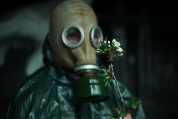 Scientist dosimetrist radiation supervisor in protective clothing and gas mask explores the danger...