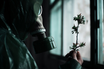 Scientist dosimetrist radiation supervisor in protective clothing and gas mask explores the danger...