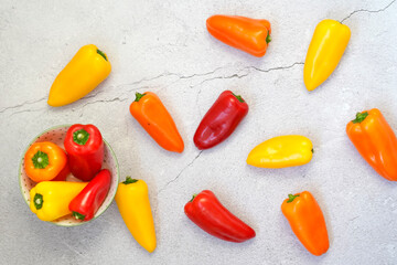 Top view of colorful peppers inside a bowl on a white ground