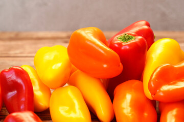Close up of colorful orange, red and yellow peppers paprika background
