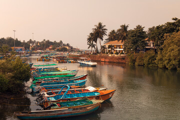 Fishing boats on an embankment of the river at sunrise