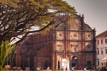A day view on The Basilica of Bom Jesus and tree in front in Goa - obrazy, fototapety, plakaty