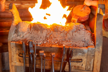 Tool in the forge against the background of the fire.