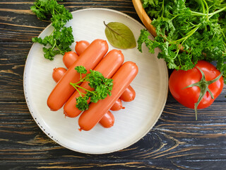 sausages, parsley on wooden background
