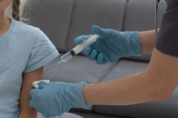 Little girl getting vaccination from pediatrician at medical office