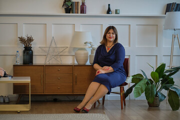 extravagant dressy lady at home. portrait of a confident mature woman. smiling woman looking at camera. Successful middle aged woman at home smiling.