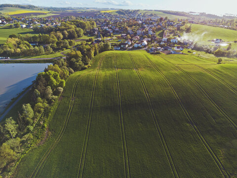 Waves on green field with small city © Lukas Tesar