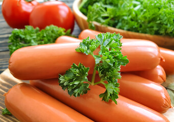 sausages, parsley on wooden background
