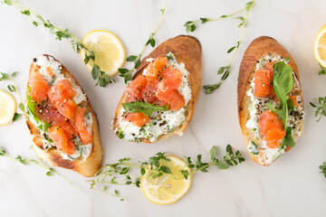 bruschettas with cream cheese and smoked salmon on a light table