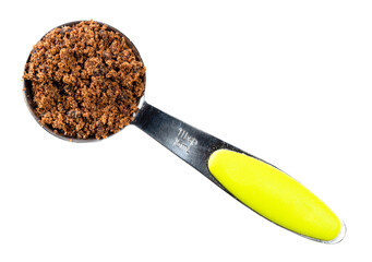 dark muscovado sugar in measuring spoon cutout