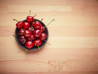 Fresh cherries on a wooden background