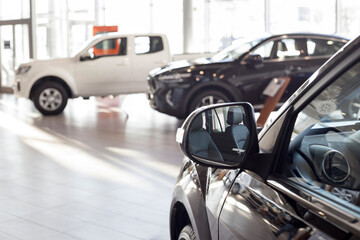 New modern unknown cars at dealer showroom. Car auto dealership. Prestigious vehicles.