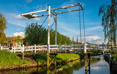 Fototapeta na wymiar Historical white wooden bridge in dutch city Etten-Leur