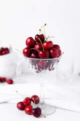 Fresh beautiful cherries in a cut crystal glass