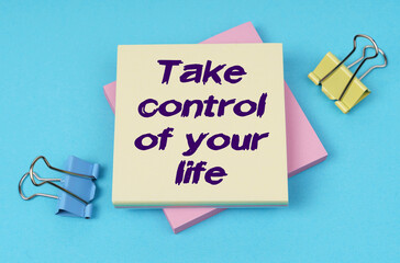 On the table are paper clips, note paper with text - Take control of your life