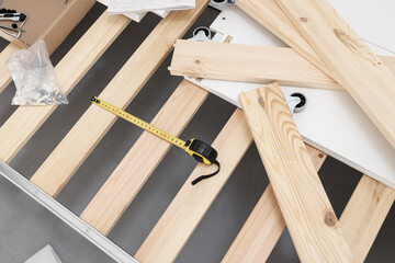 View of a bed being assembled. Furniture assembly