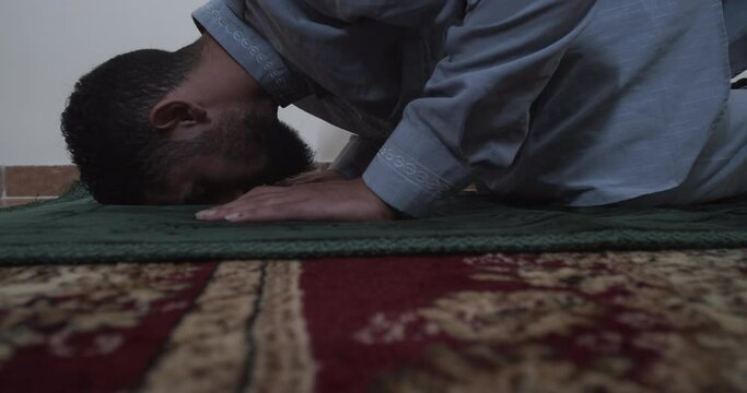 Close up on a Muslim man bowing down praying