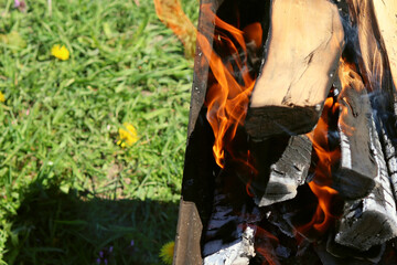 Burning wood for grilling, coals