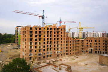 Aerial view of city residential area with high apartment buildings under construction.