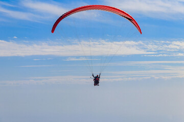 Paragliders in blue sky. Concept of active lifestyle and extreme sport adventure