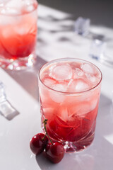 Beautiful red cherry cocktail in the summer sunshine