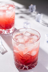 Beautiful red cherry cocktail in the summer sunshine