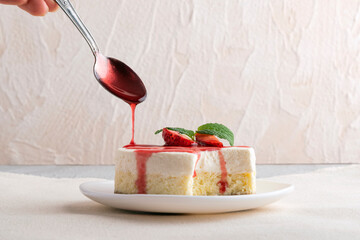 Fruit cheesecake, garnished with fresh strawberries and berry juice.