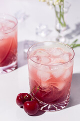 Fototapeta na wymiar Beautiful red cherry cocktail in the summer sunshine