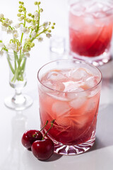 Beautiful red cherry cocktail in the summer sunshine