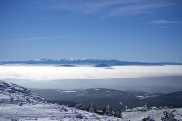 Fototapeta na wymiar view of snowy mountains in fog