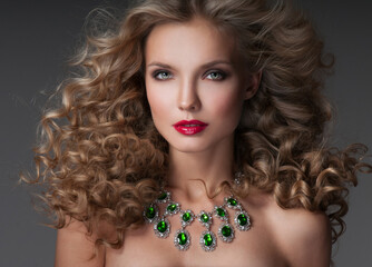 Beautiful woman with magnificent curly hair. Red lipstick. Necklace.