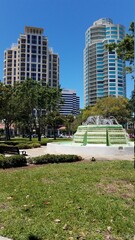 Water fountain in a city park with skyscrapers