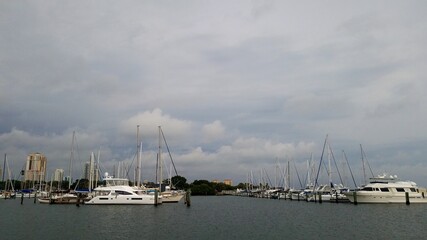 Fototapeta na wymiar Boats docked at the marina with dark clouds