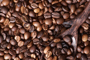 Coffee beans and grinder on table with rustic background