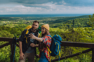 A couple of hiker taking selfie with a smartphone while spending day in nature