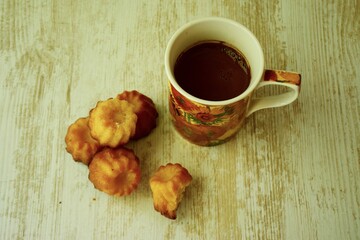 cup of tea and caneles